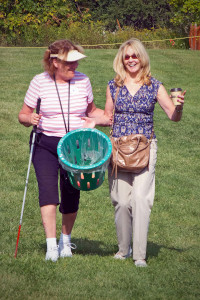 Two participants in an apple orchard on our Bus Trip to Saint Jacobs Farmer's Market & Apple picking.